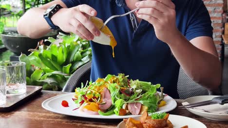 person eating a salad outdoor