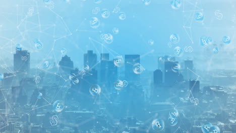 animation of network of connections and bitcoin symbols floating against aerial view of cityscape