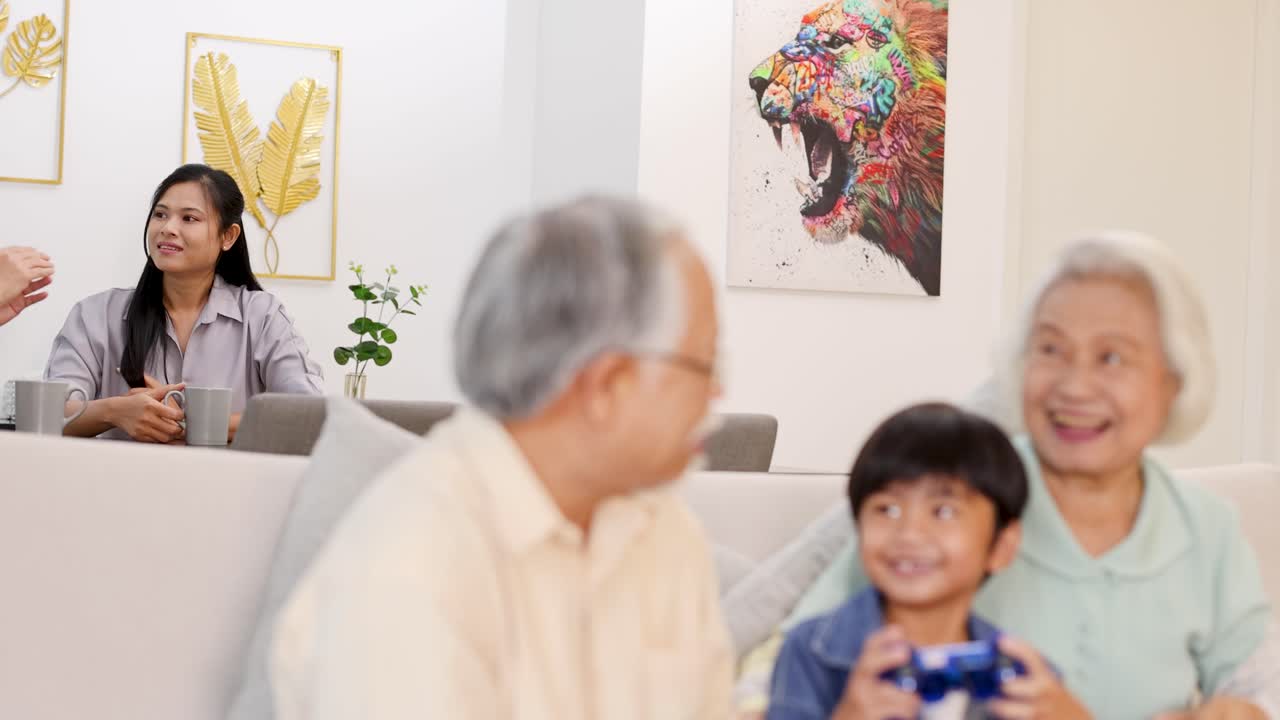 A family shares laughter and games in a bright, art-filled living room, capturing a moment of happiness and connection