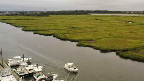 An-aerial-view-of-a-small-fishing-boat-sailing-in-Freeport,-NY