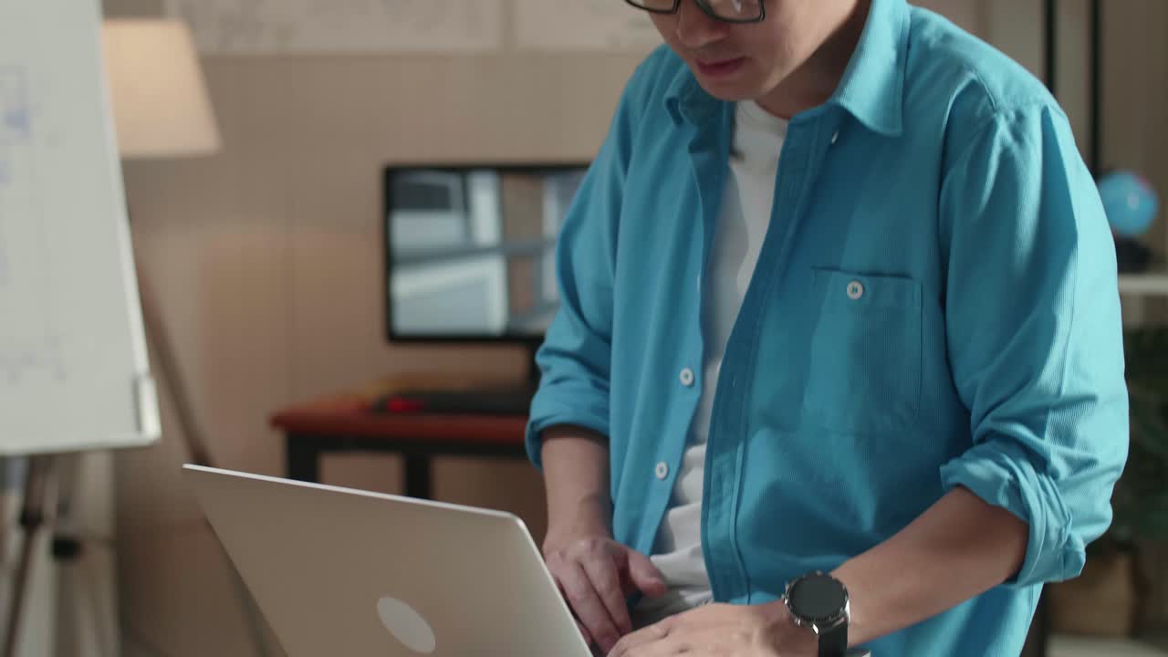 Close Up Of Asian Man Engineer Sitting On The Table And Using A Laptop To Work At The Office