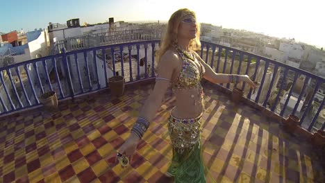 Belly-dancer-rejoices-at-sunset-as-she-dances-on-a-rooftop-in-Morocco