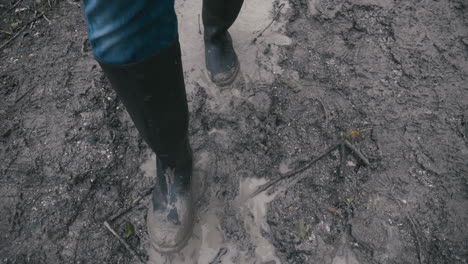 muddy boots walking along a muddy path