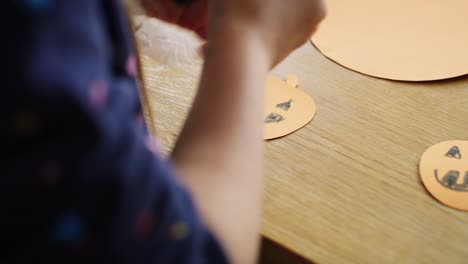 child preparing decorations for halloween