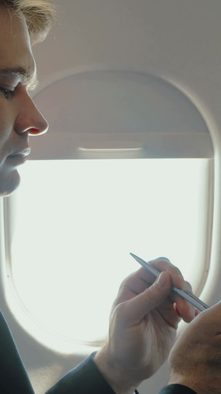 Man Writing on Airplane