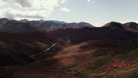 Moody-aerial-drone-shot-of-Salt-Lake-City-mountain-range-with-fall-colored-leaves-at-60fps