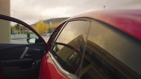 Woman-sitting-in-an-electirc-vehicle-by-charging-station