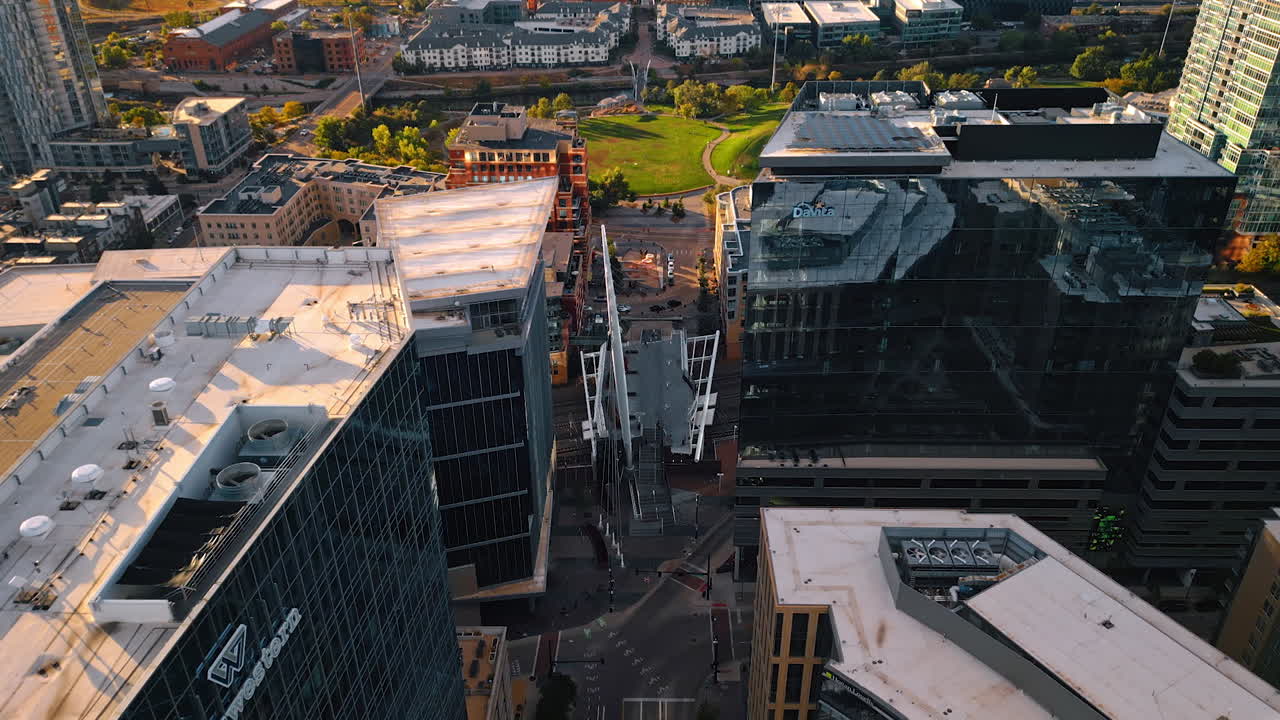 Denver, USA, 24 August 2025: Over the tops of modern high-rise building in the cityscape of Denver, Colorado, USA. Approaching the park located in the downtown