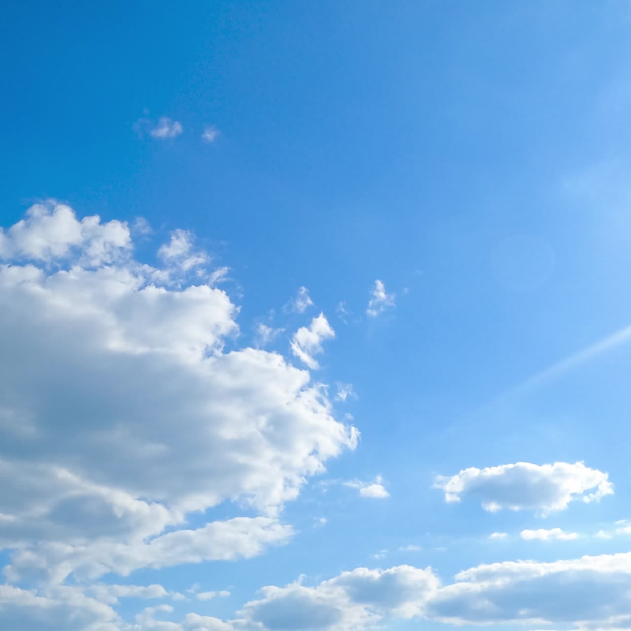Wonderful light clouds against beaming sun. Cloudscape formation timelapse on fantastic summer day