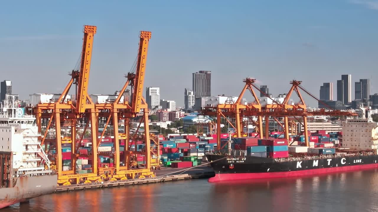 View of Bangkok port with cranes and shipping containers in daytime