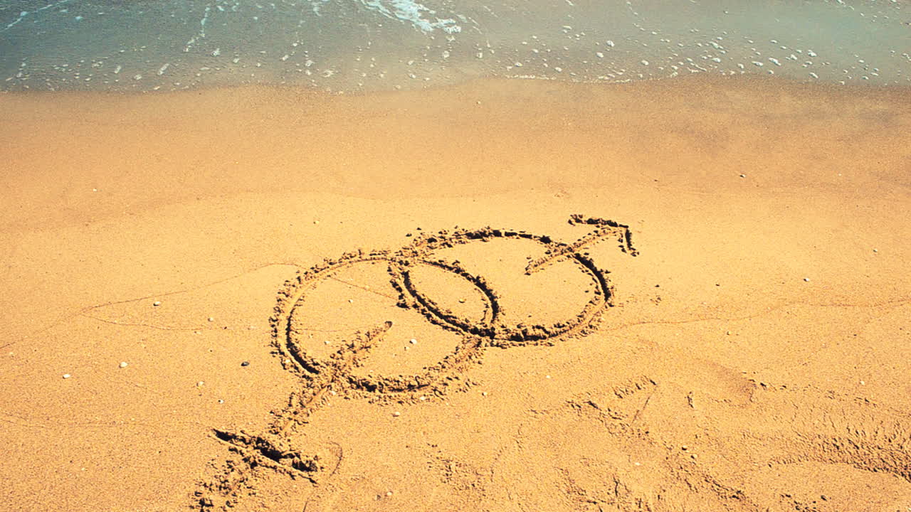 Simbolo sulla sabbia. Riprese in spiaggia.