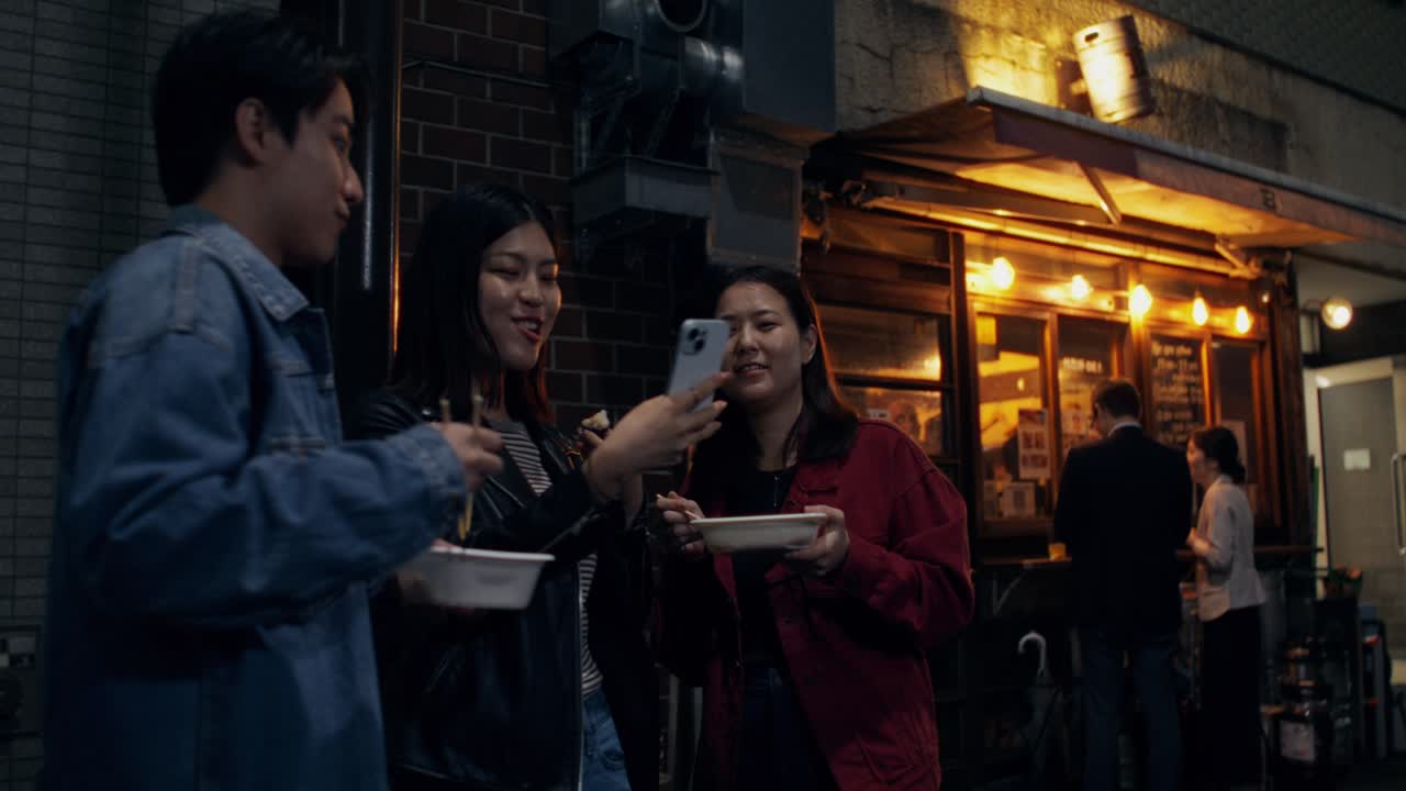 Friends enjoying dinner and a selfie at night