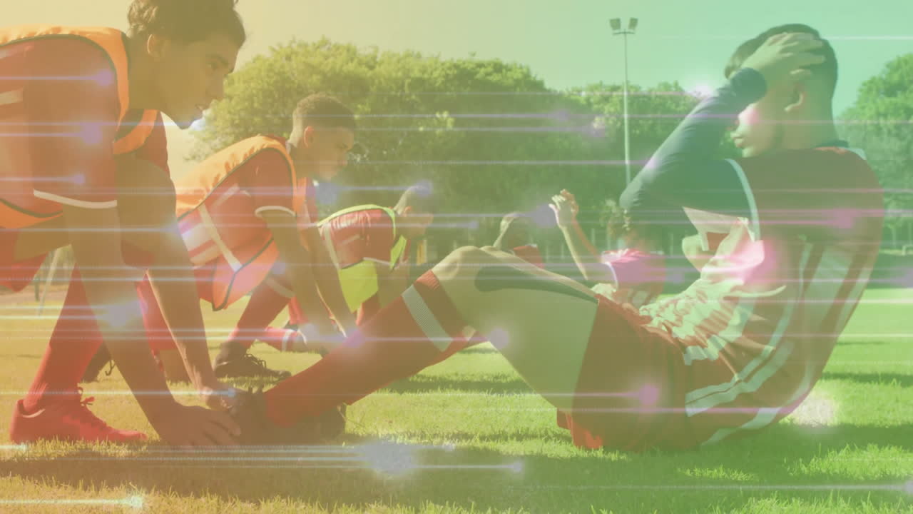 Soccer teammates performing partner sit-up exercise on grass field, with animated sports icons