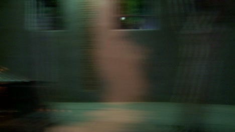 a car travels along a street at night in santa monica california as seen through the side window 4