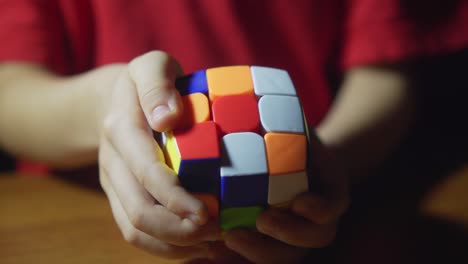 close up view of kid enjoying rubik's cube at home