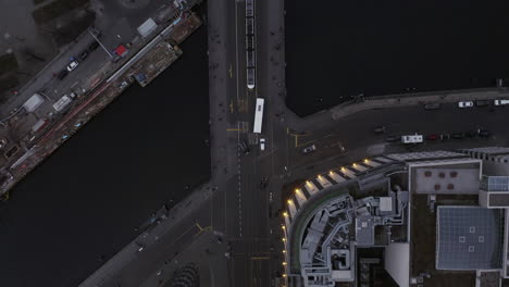 Aerial-birds-eye-overhead-top-down-view-buildings-in-city-along-river.-Tracking-of-tram-passing-over-bridge.-Berlin,-Germany