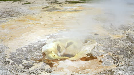 steam rising up from small crater after high temperature breaking earth crust - geothermal energy at hveravellir,iceland