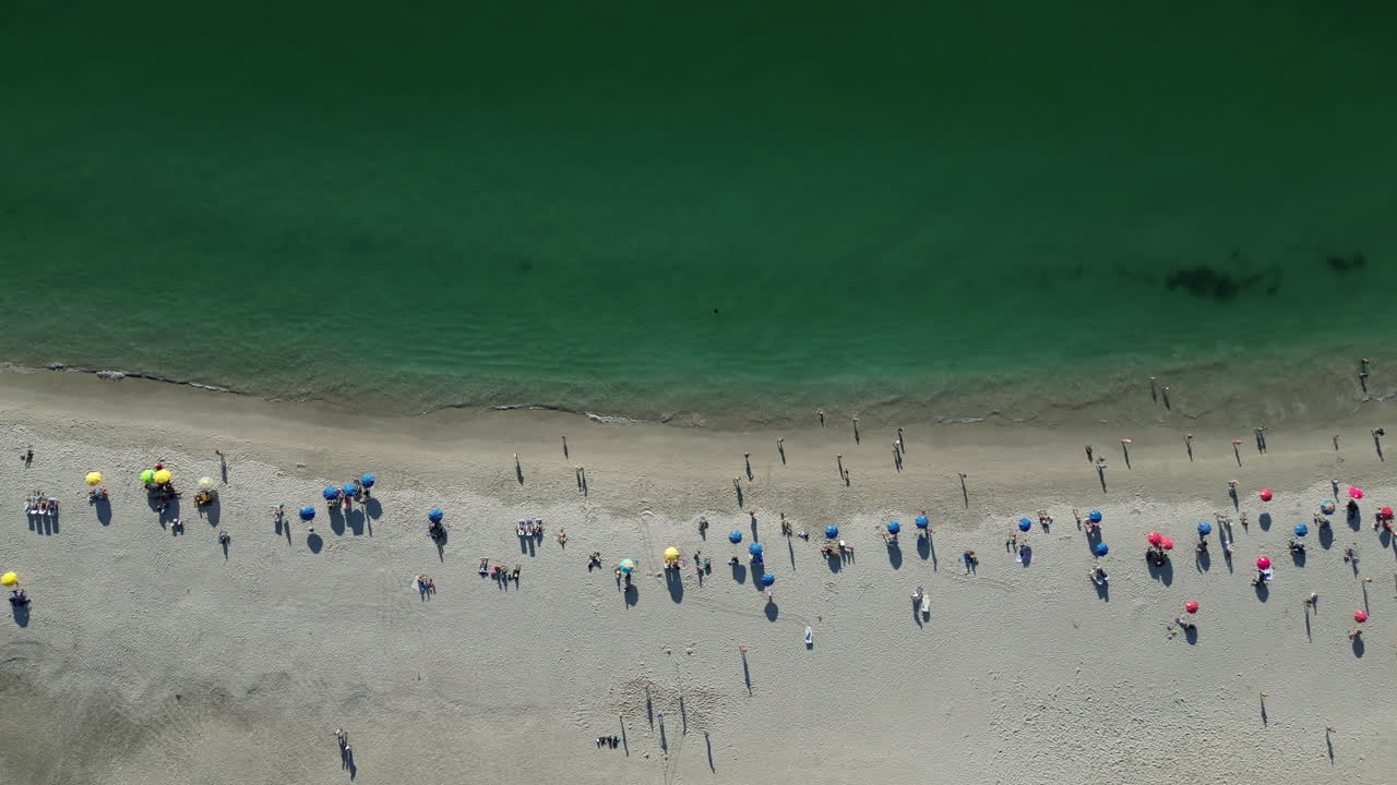 Drone shot soaring slowly above Cape Town's stunning beach, showcasing the crystal-clear waters and golden sands. Captured with a Mavic Pro, this footage highlights the natural beauty of South Africa.