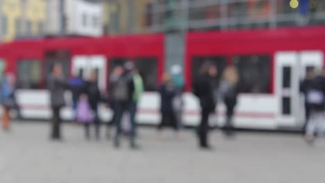 blurry people moving in downtown erfurt, historic city in germany