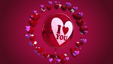 high quality seasonal motion graphic celebrating st valentine's day, with pink and red color scheme, balloon and a circle of spinning love hearts - with the message "i love you