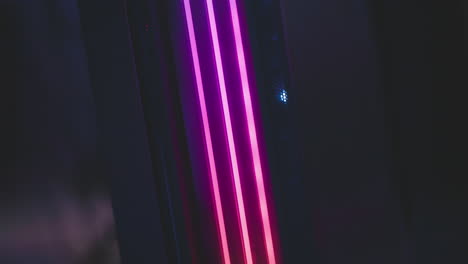 close up of sound system glowing with dynamic color hues including green, yellow, and magenta, creating vibrant futuristic mood in modern dark studio environment with soft ambient lighting