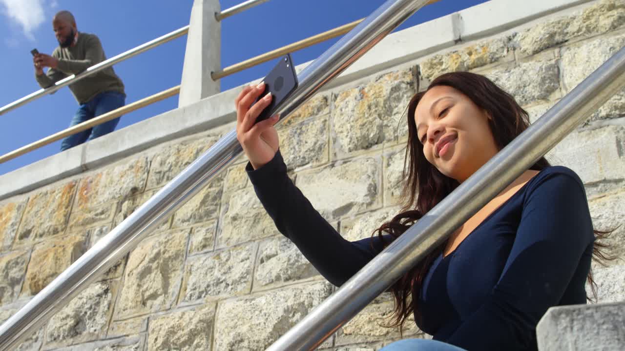 mujer tomando una selfie con teléfono móvil en las escaleras 4k