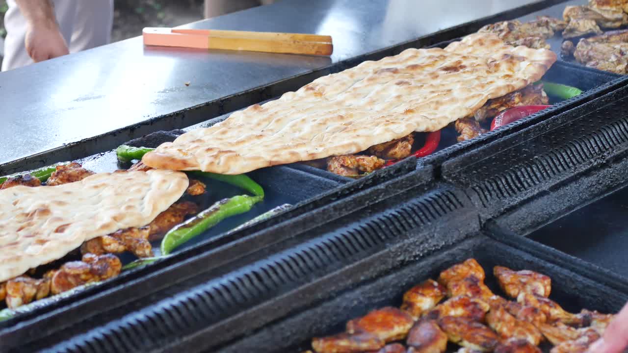 Cooking Chicken Kebab and Flatbread on a Grill