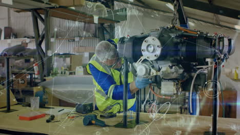 engineer working on machinery with technical diagrams and gears animation over workshop