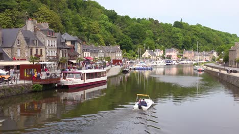 establishing the pretty town of dinan france with boat on rance river