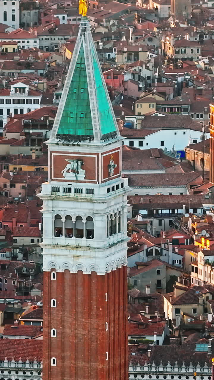 Aerial drone view of St Mark's Campanile with Venice, Italy on the background, at sunset. Vertical