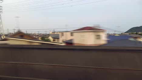 the view of tokyo passing from inside of the shinkansen bullet train