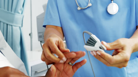 female doctor operating heartbeat machine