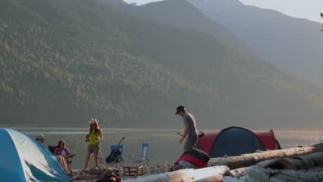 group of friends camping near riverside 4k