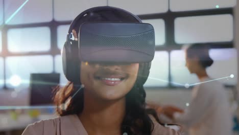 Woman-typing-in-the-air-while-wearing-a-virtual-reality-headset-in-the-office