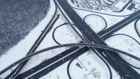 aerial view of a freeway intersection snow-covered in winter.