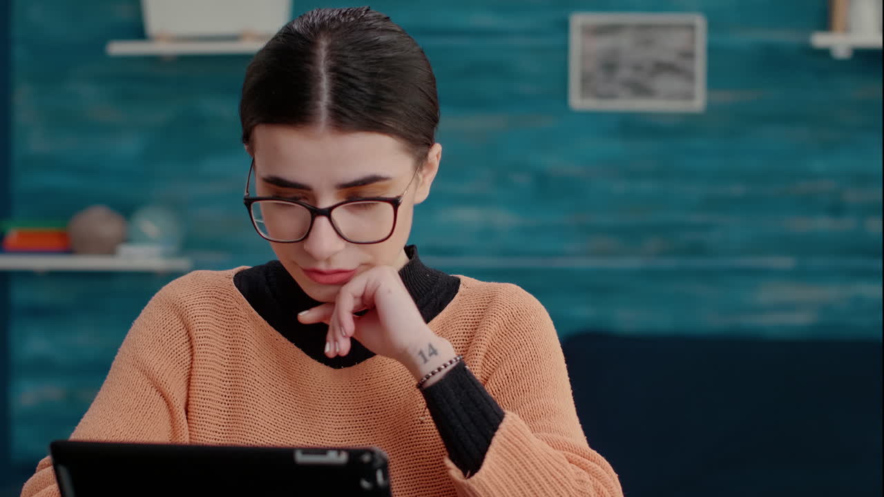Female student doing assignment on digital tablet with stylus