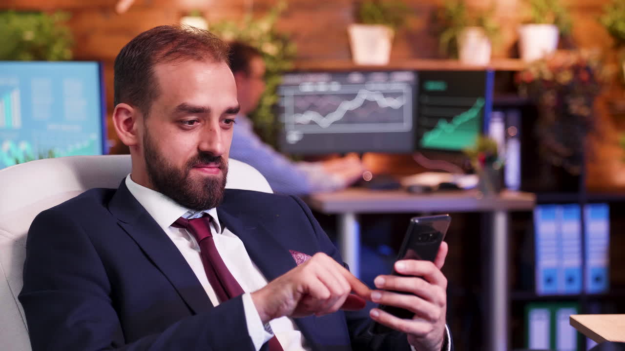 Man in suit using smartphone in office
