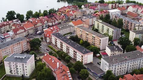 City-of-Elk-with-many-apartment-buildings-on-lake-coastline,-aerial-view