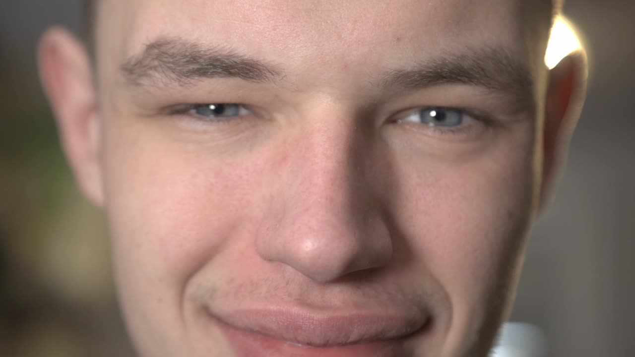 Closeup Face Of A Young Man Smiling At The Camera - Closeup Shot