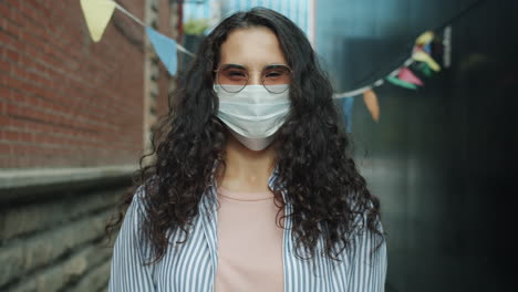 woman wearing mask in an alley