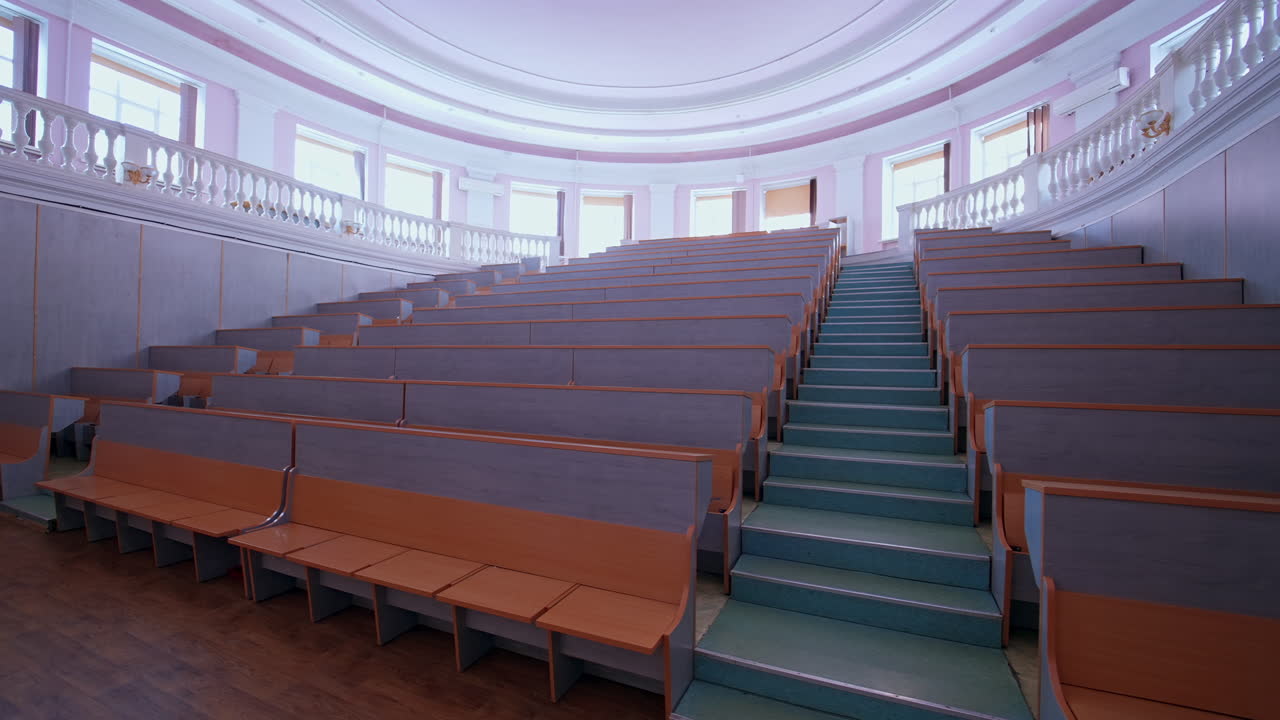 Wooden panelled university lecture theatre. Classroom with wooden furniture without student