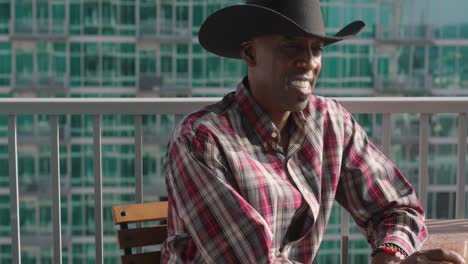 Black-man-with-cowboy-hat-smiling-and-laughing