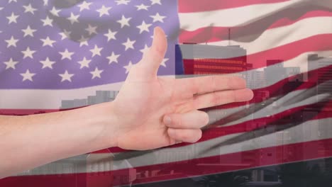 Animation-of-caucasian-hand-making-gun-gesture-over-waving-american-flag-and-city-buildings