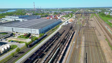 Flying-above-industrial-railroad-station-with-cargo-trains-and-freight-containers