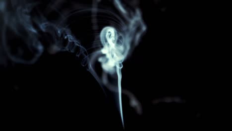 Smoke-rising-on-black-background