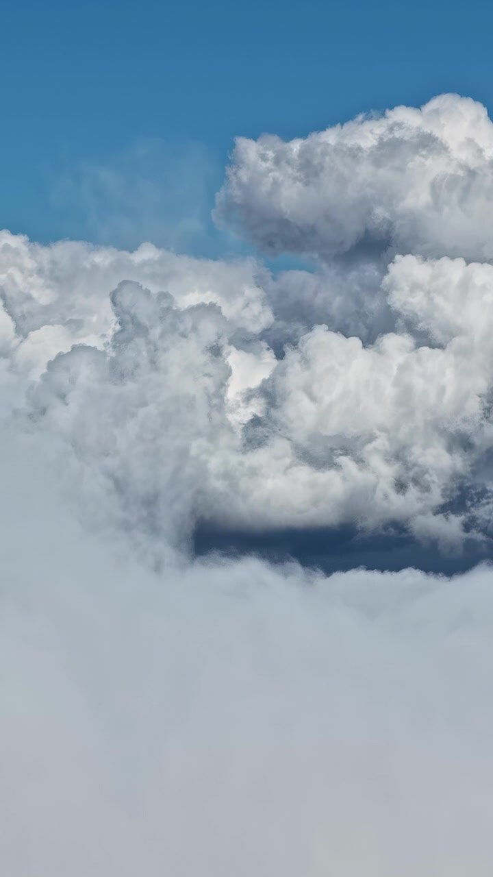 Vertical social ratio aerial video of clouds in the blue sky. Filmed in Riga, Latvia. Produced in 1080x1920 and with Rec709 color.