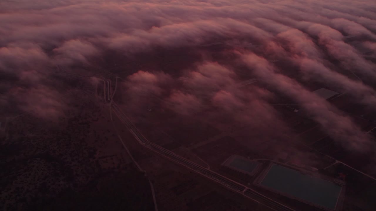 Vivid dawn over serene urban landscape with soft clouds