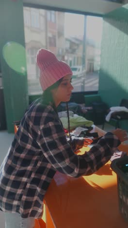 woman sorting clothes at a donation center