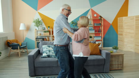 senior couple dancing in living room