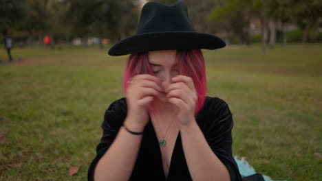 woman with pink hair in a park